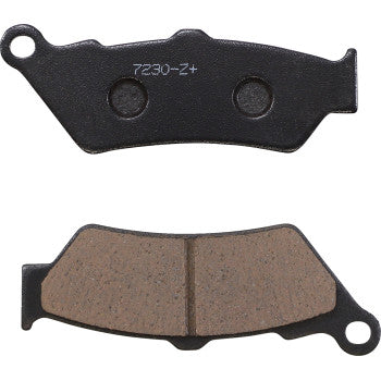 Two Victory Z+ Brake Pads by Lyndall Racing Brakes are shown: the top pad displays its black metal backing with code 7230-Z+, and the bottom reveals the brown friction surface. Both feature mounting tabs and are built for long life.