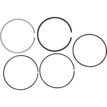 Five piston rings from the Wossner Piston Ring Set 93.00 mm, varying in thickness and color, are arranged in two rows on a white background; the top right ring displays a textured edge.