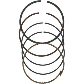 Five piston rings are stacked vertically—the top four are solid and dark, while the bottom is metallic with a wavy texture—making this Wiseco Ring Set perfect for those seeking quality and durability.