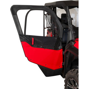 A close-up of a red and black side door from the Honda 1000 6 Pioneer with Seizmiks Upper Door Kit, showing factory integration, a large tire, and part of the cab enclosure interior.