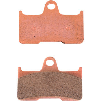 Copper-colored rectangular brake pads with a central circular mounting hole and textured friction surface on one side.