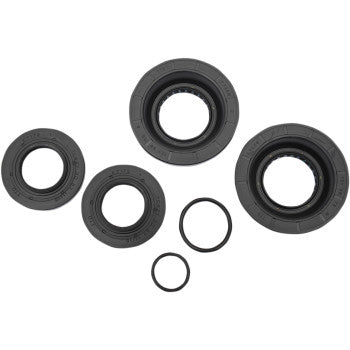 Four black TC rubber seals and three smaller O-rings are displayed on a white background—these essential parts are included in the Honda Differential Seal Kit Rear by Moose Offroad for your next differential service.