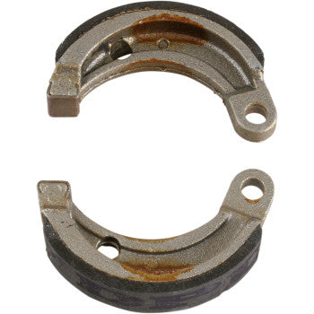Two curved metal brake shoes with mounting holes, worn surfaces, and slight rust spots.
