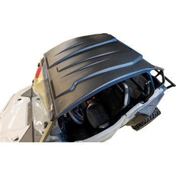 Black molded UTV roof with raised ridges, designed for exact offroad fitment, mounted on white vehicle frame.
