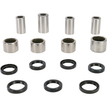 Set of silver metal cylindrical bearings and black rubber seals arranged in four matching pairs for linkage rebuild kit.