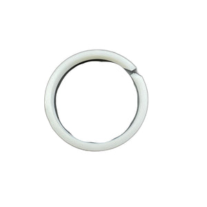 A round, scratched metallic disc—likely part of the Kit, Piston Ring by Polaris—is partly encircled by a white plastic ring with a small gap, both items displayed on a plain white background.