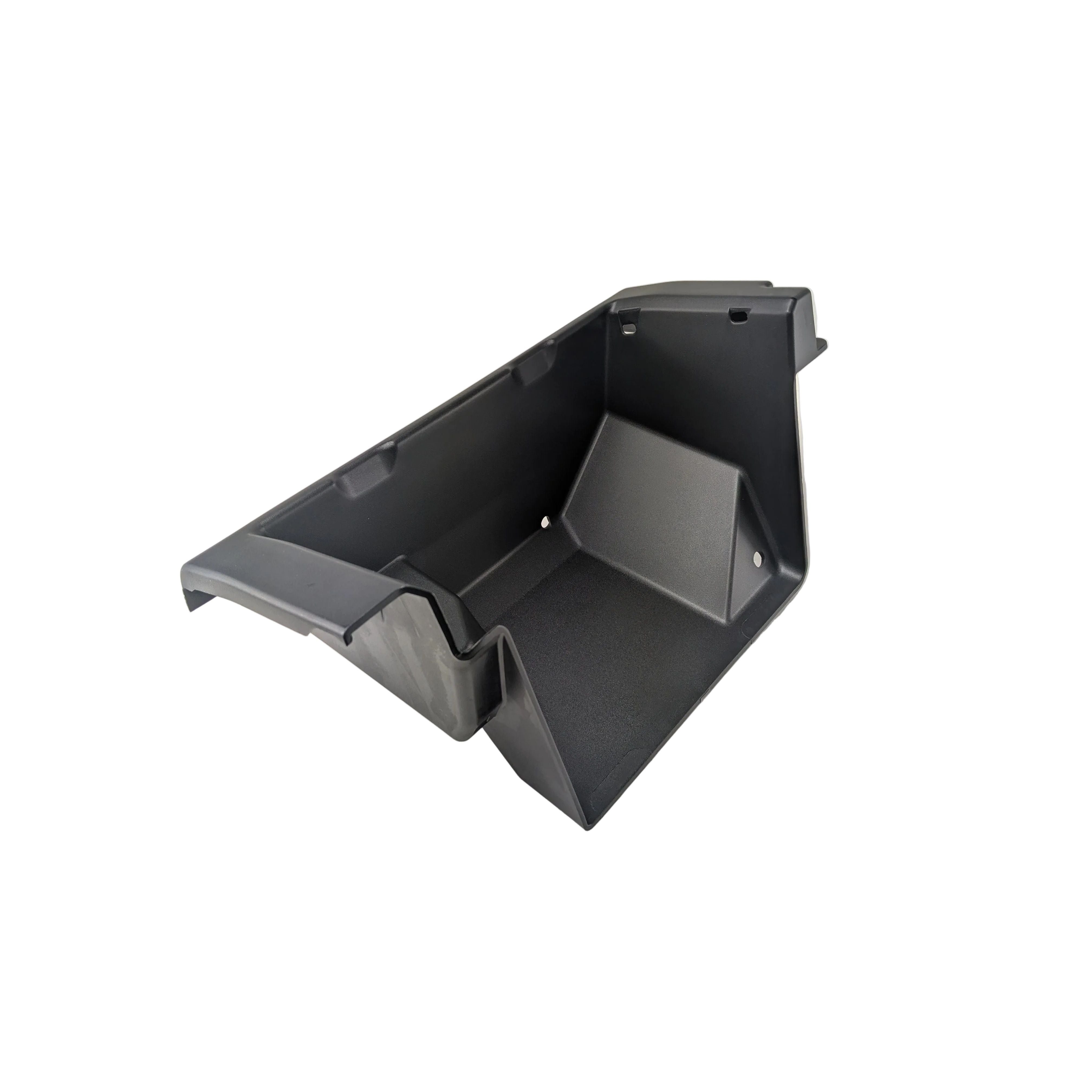 Black molded plastic front lower storage box with angular design and mounting points.