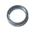 Silver metal circular bushing with a single split gap on a light surface.