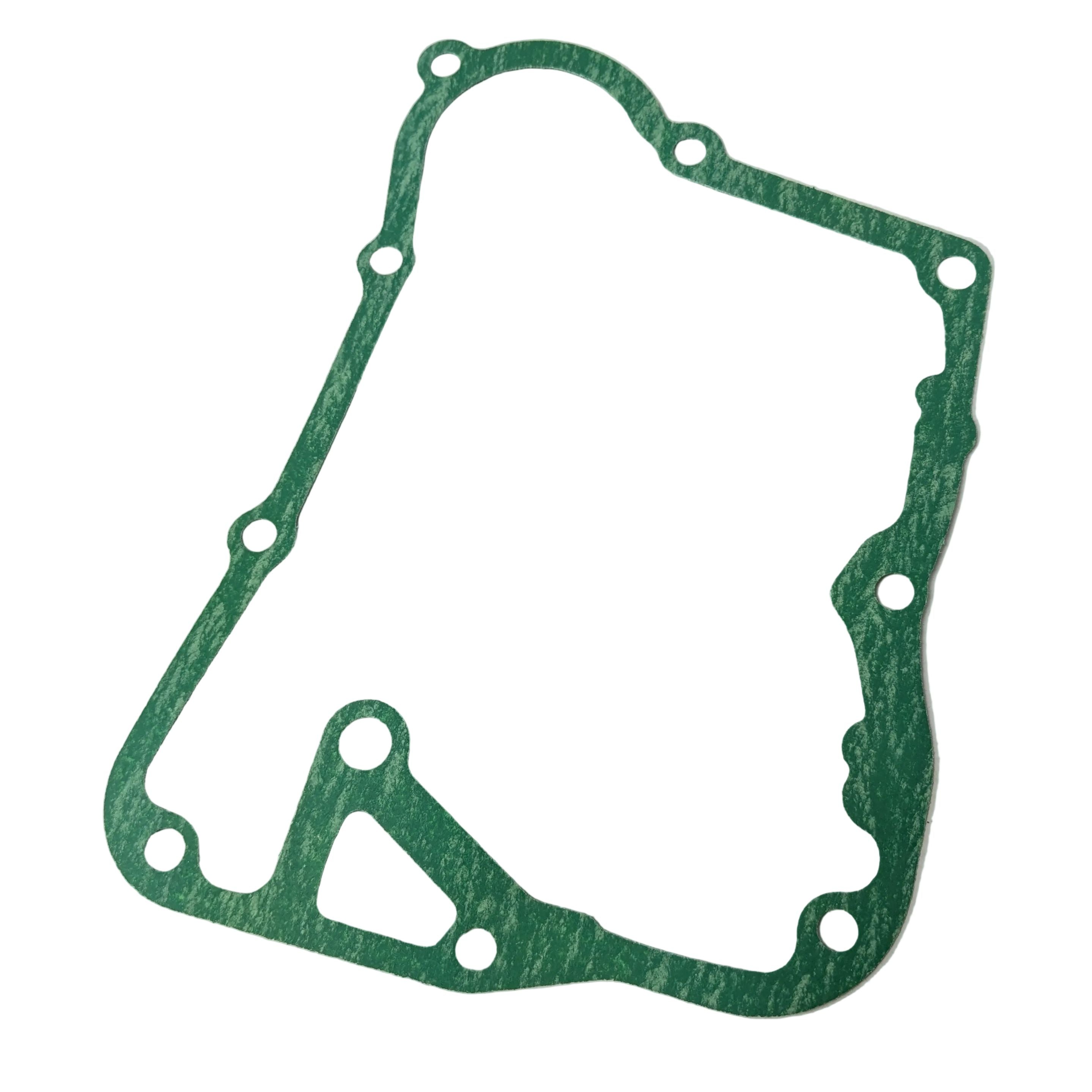 Green fibrous crankcase cover gasket with irregular rounded shape and multiple bolt holes.