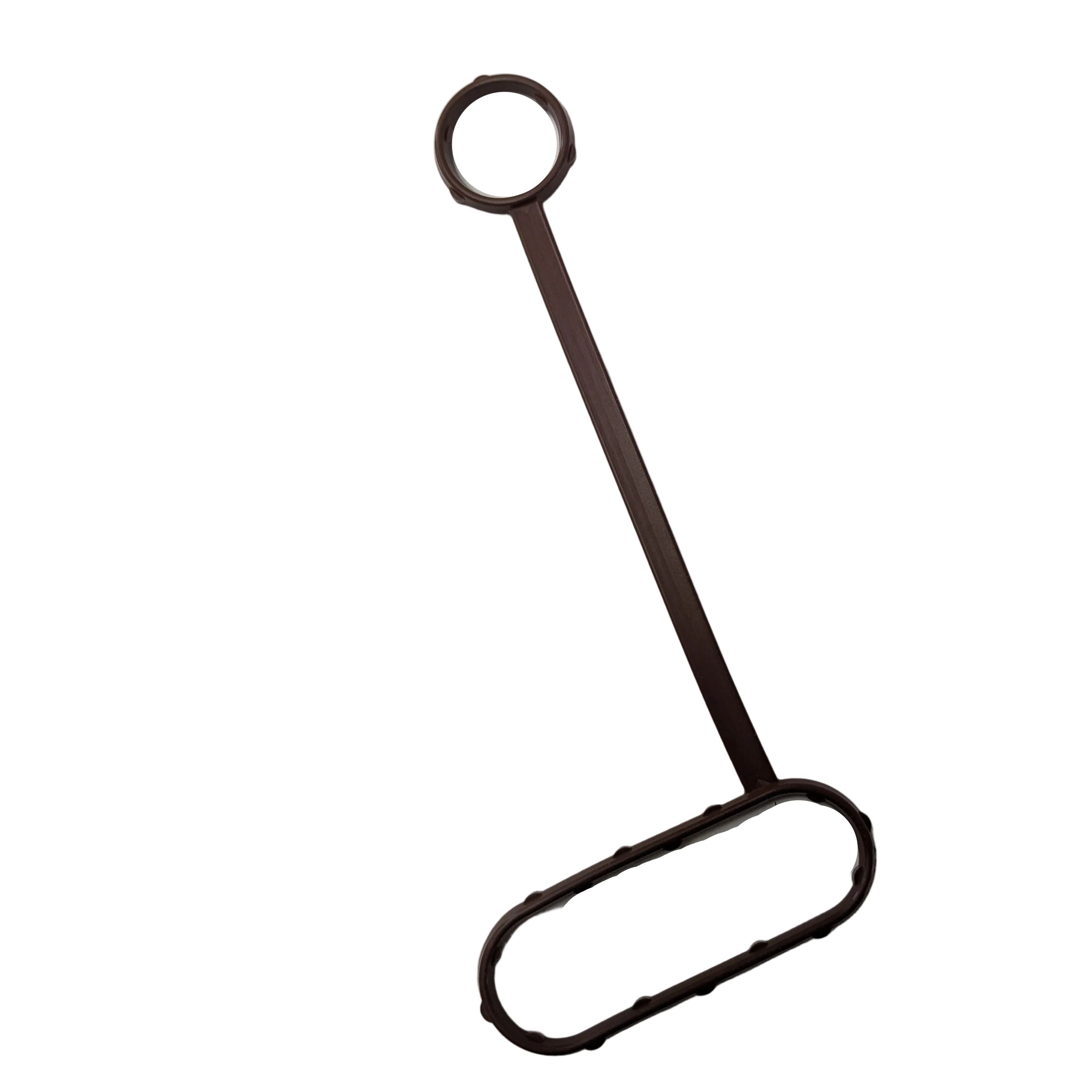 Black rubber gasket with an attached long handle loop for oil cooler sealing.