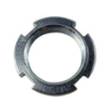 Silver metal locking nut with three notches and engraved markings on the outer edge.