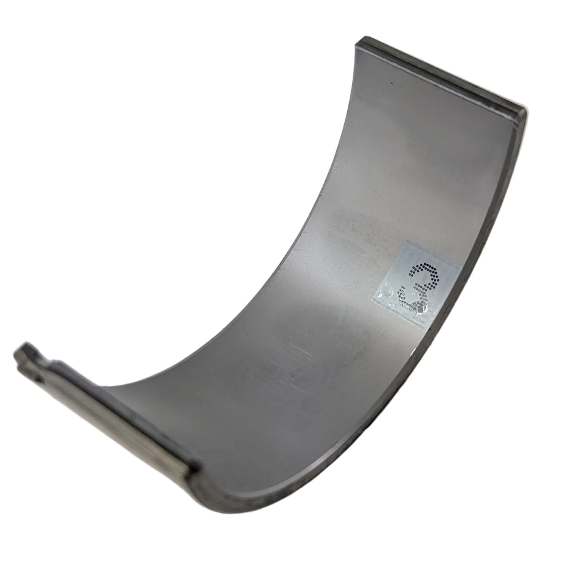 Curved metallic lower grade 3 bearing main with smooth surface and numeric marking.