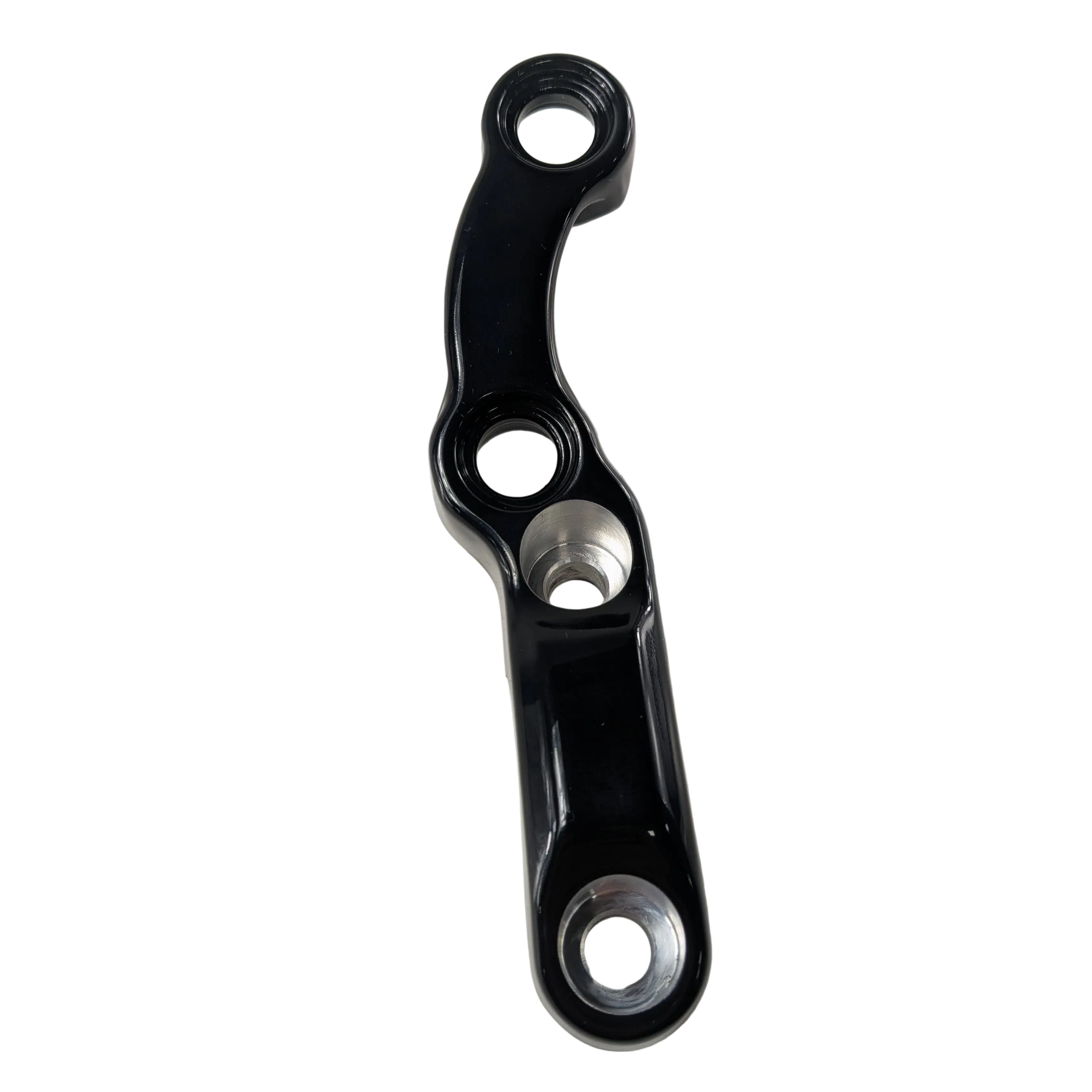 Black anodized aluminum handlebar riser cap with three mounting holes and contoured design.
