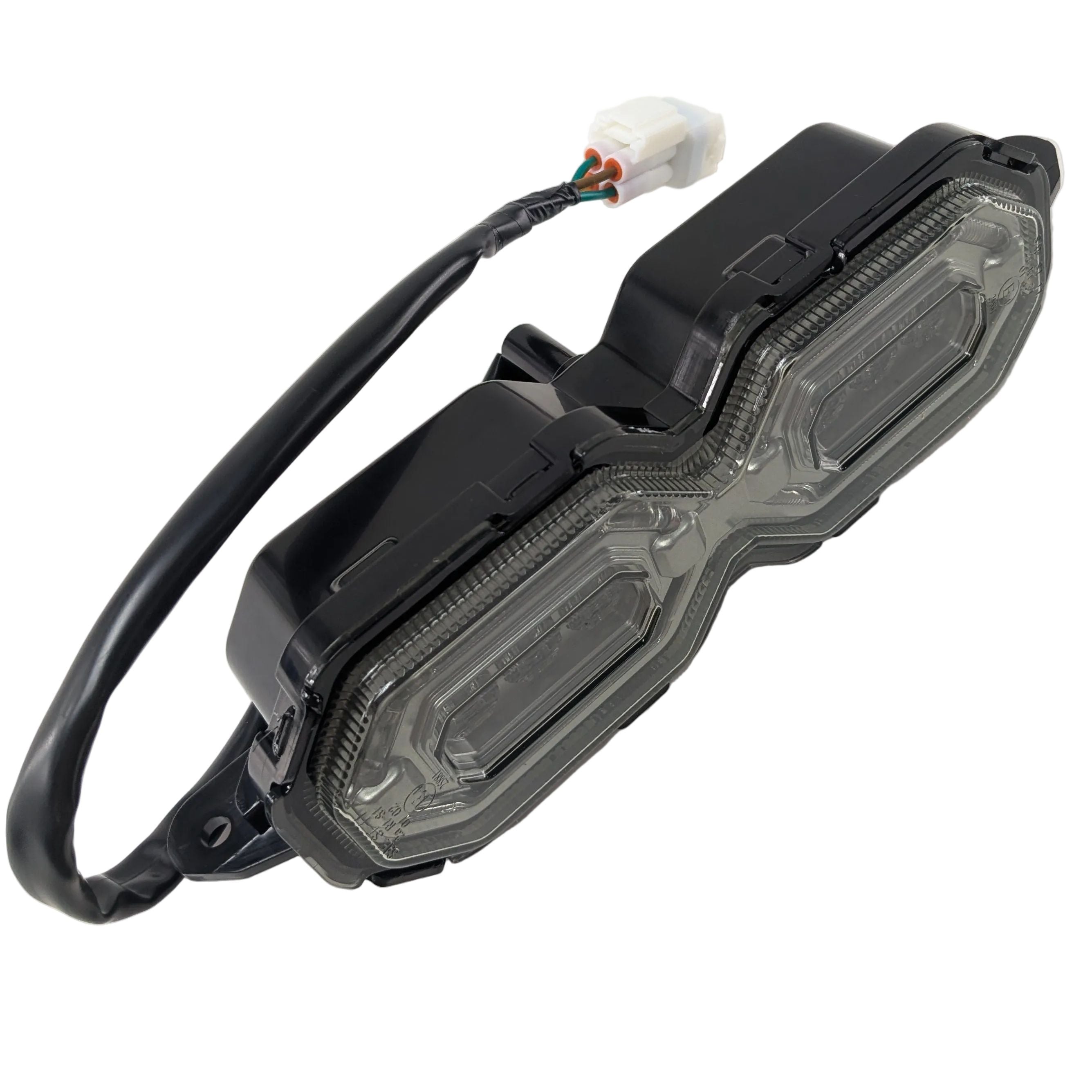 Clear lens dual-chamber tail light with black housing and attached wiring harness.