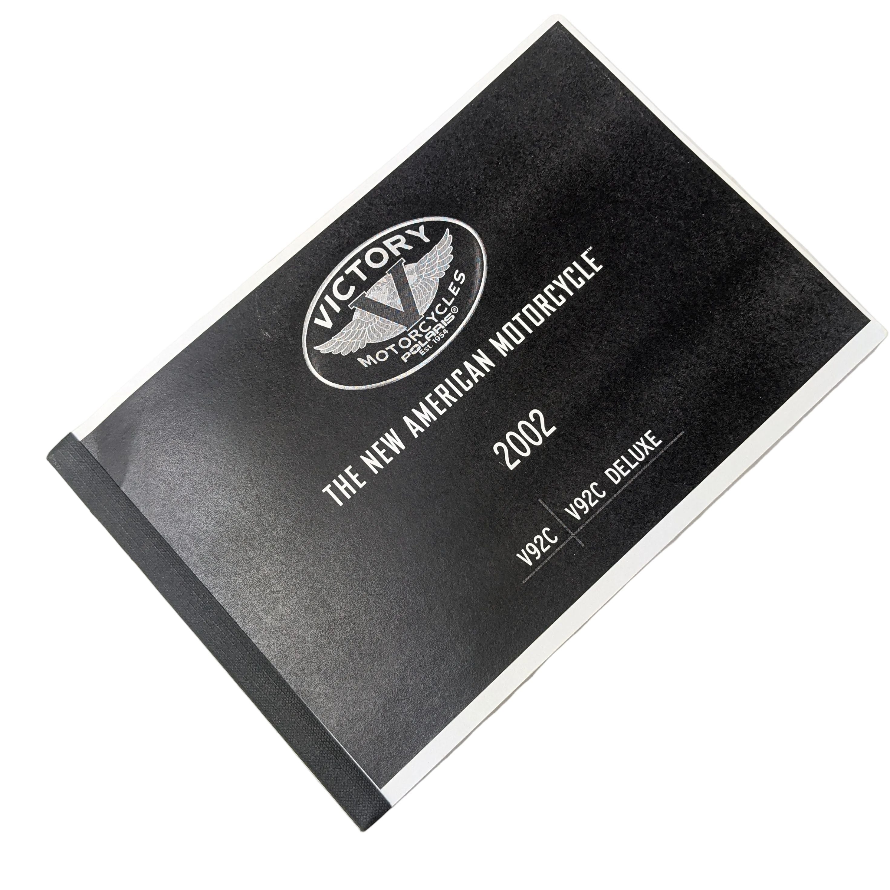 Black and white Owner's Manual for 2002 Victory motorcycles with embossed logo and text on cover.