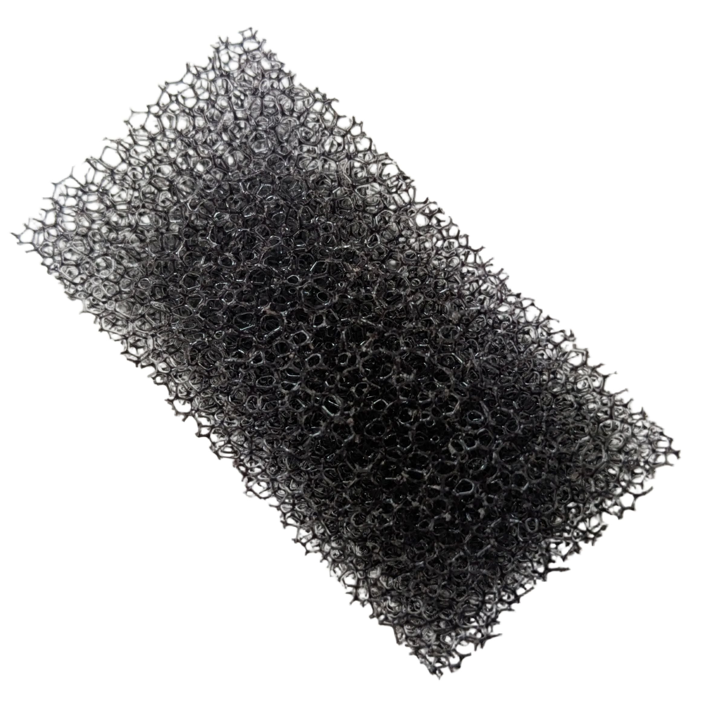 Rectangular black porous foam filter with rough textured surface for ventilation systems.