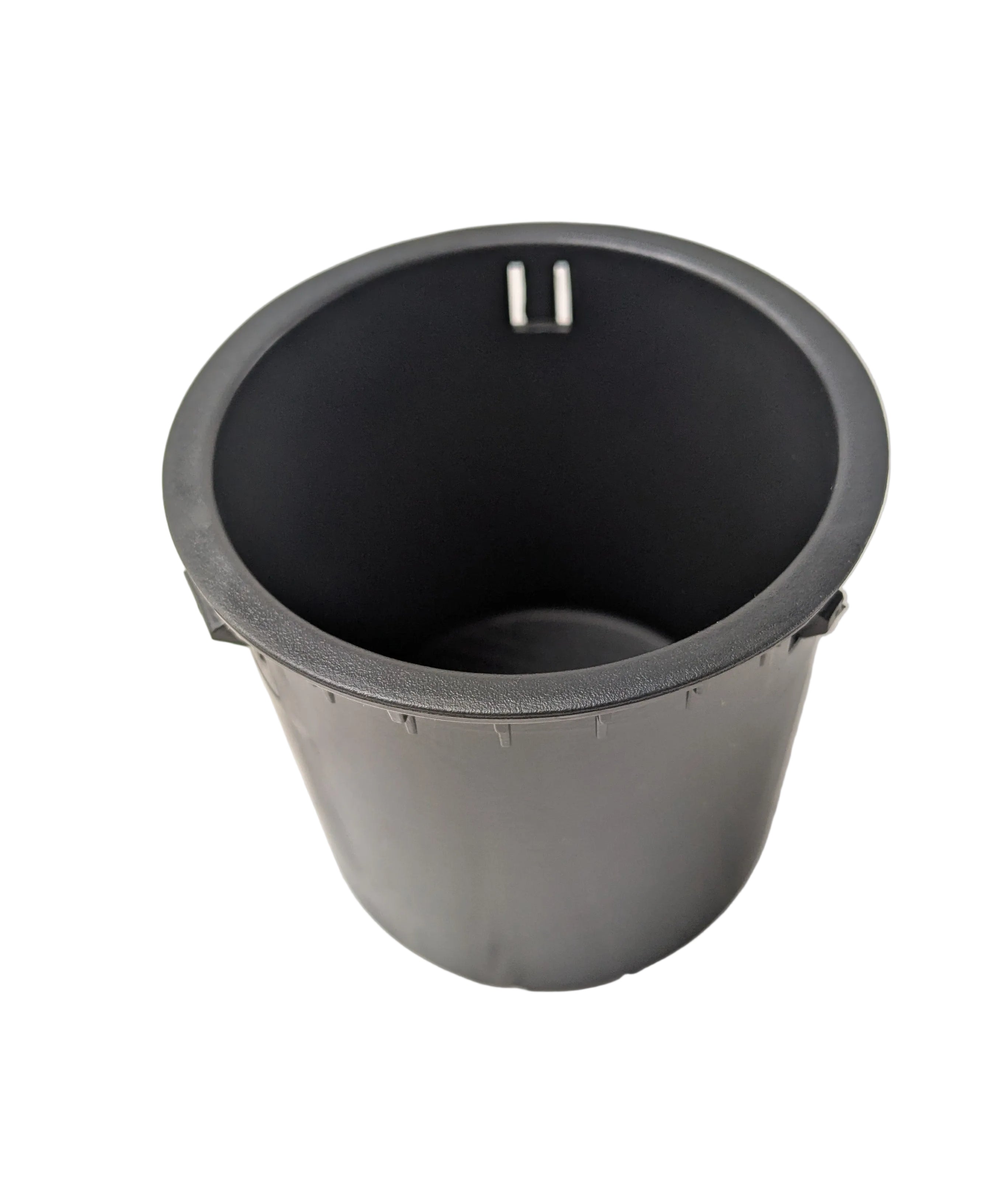 Black cylindrical plastic dash cup holder with smooth interior and small notch on the rim.