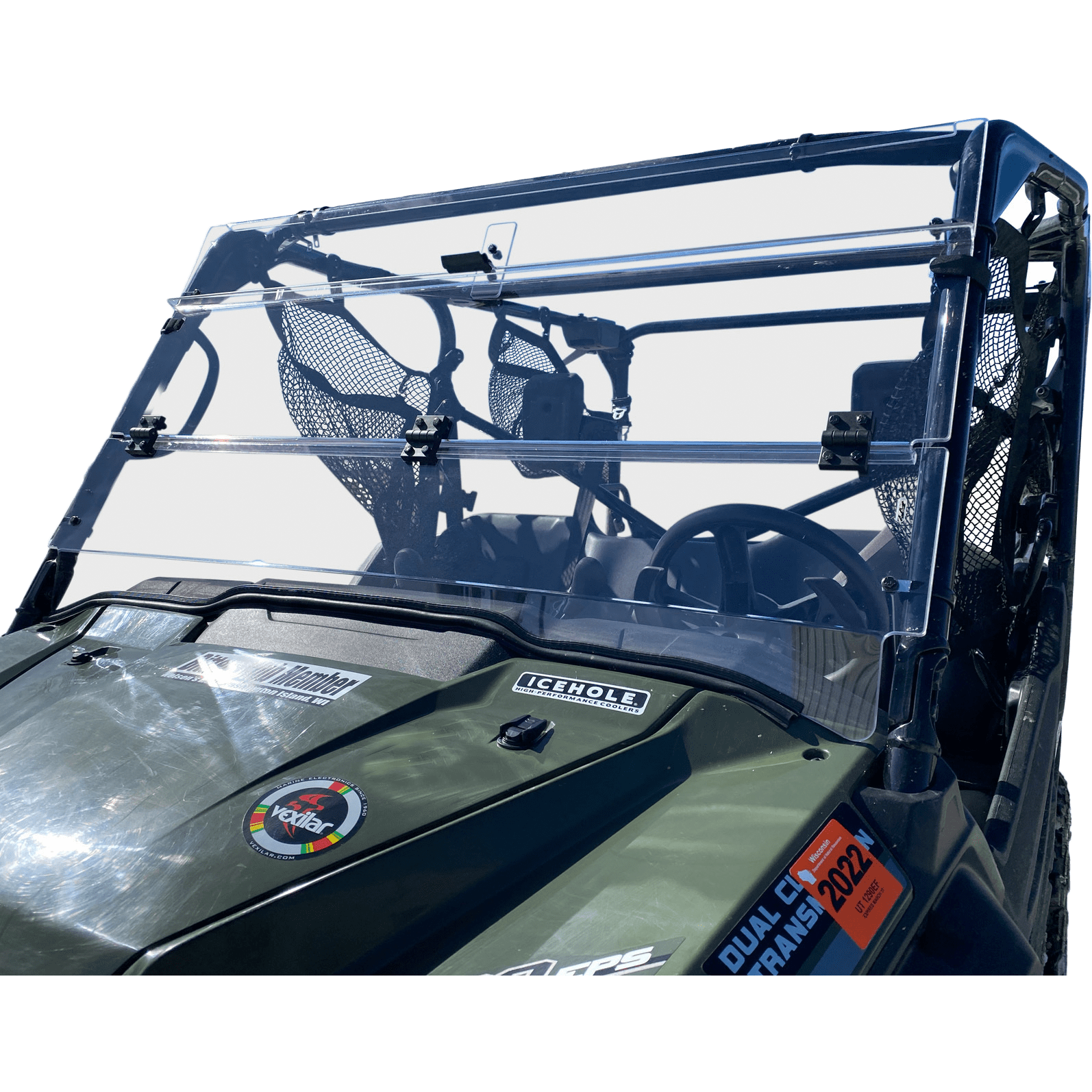 A close-up view of the Folding Windshield by Open Trail on a green off-road utility vehicle, showing mesh storage pockets, mounted equipment, and hood stickers—engineered to reduce water intrusion and maximize airflow.