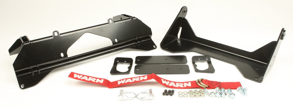 A Kawasaki Provantage Front Snow Plow Mounting Kit by Warn, in black metal with brackets, corrosion resistance, included hardware, two red WARN straps, bolts, washers, and clips arranged on a white background.