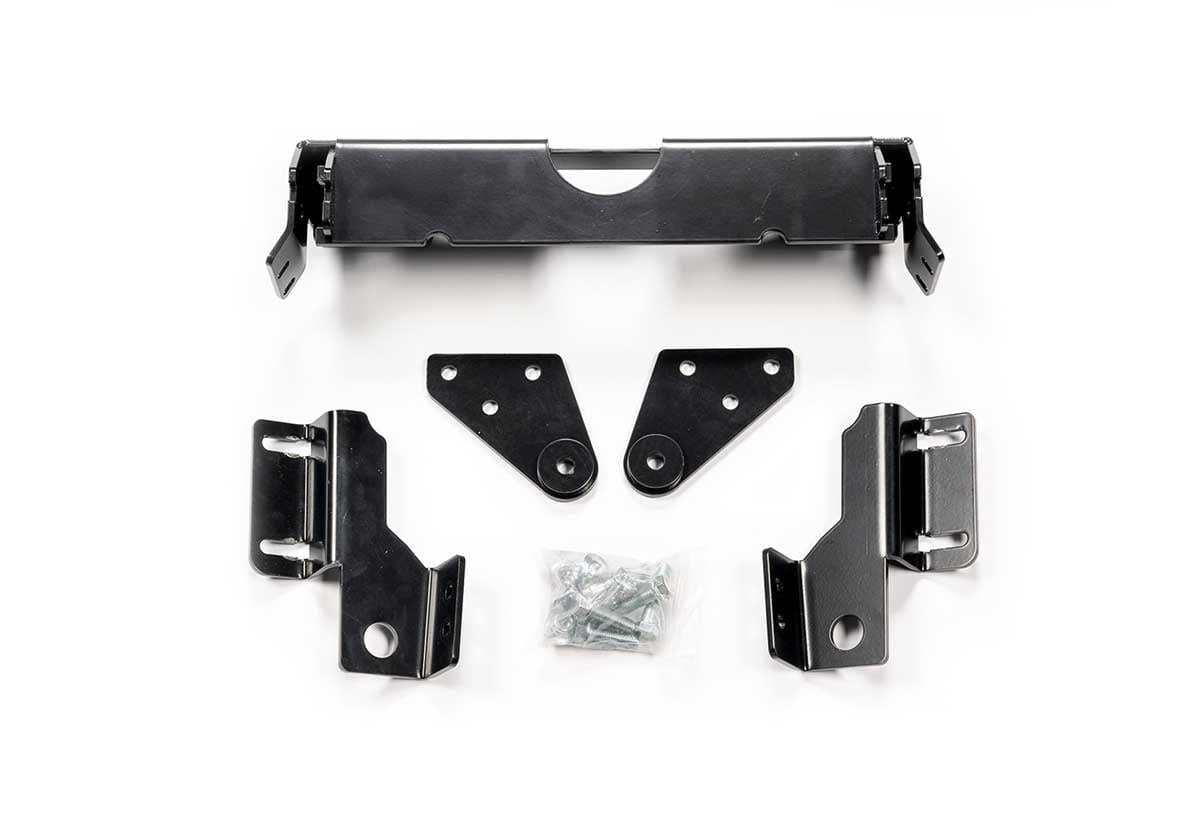 The Polaris Sportsman (2021) Provantage Front Snow Plow Mounting Kit by Warn includes black powder-coated metal brackets, plates, and a bag of screws, each displayed separately on a white background.