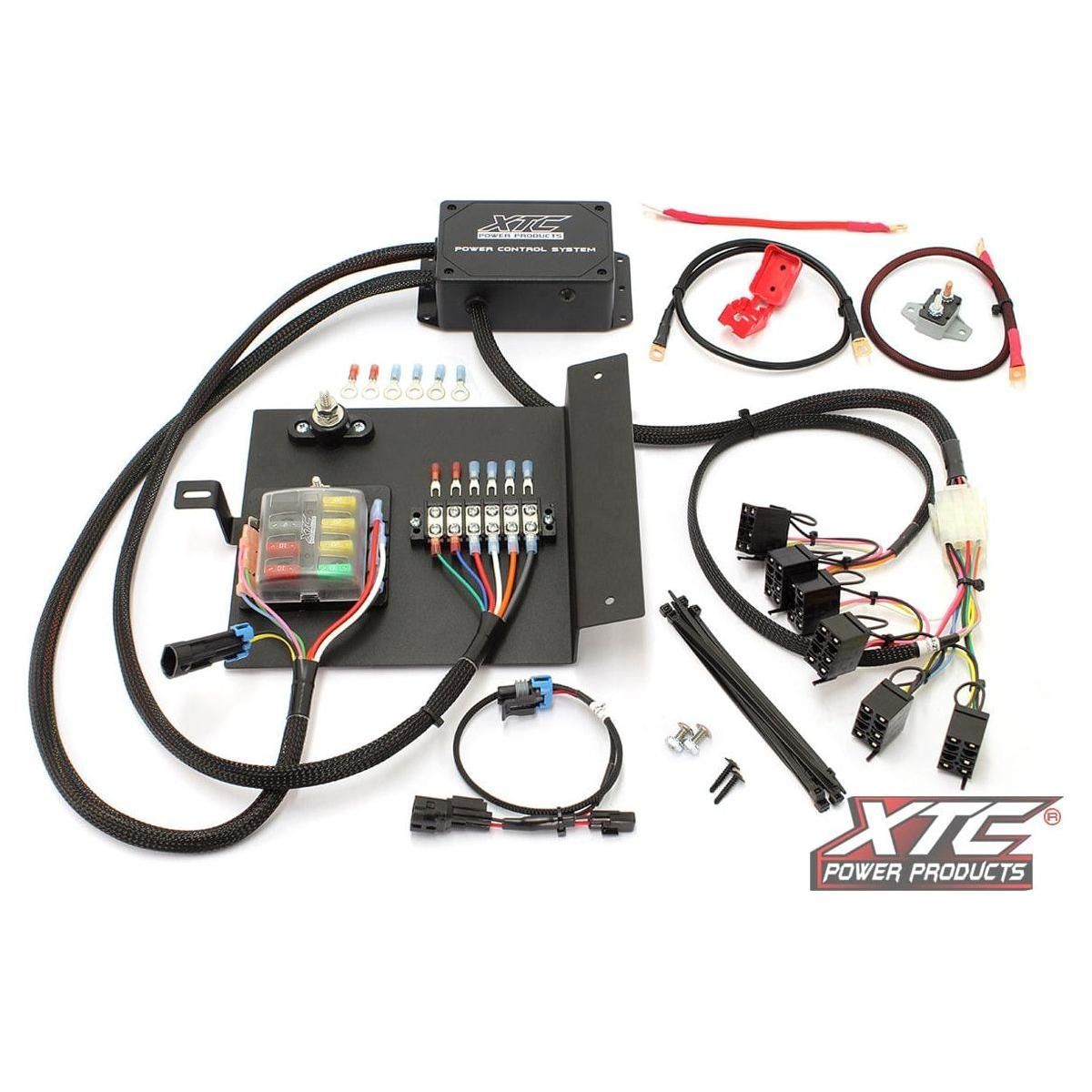 The Plug N Play Power Control 6 Switch Not Included Hon by XTC Power is shown with cables, fuses, connectors, and mounting hardware on a white background. XTC Power Products branding is visible on the components and in the bottom right corner.