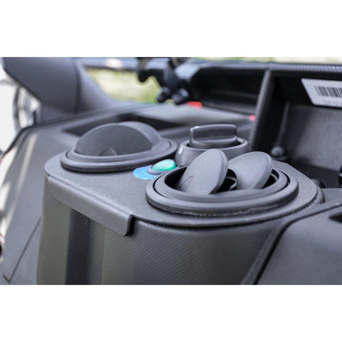 Close-up of the UTV Cab Heater by Open Trail dashboard, highlighting two circular air vents, control knobs, and buttons on a textured black surface. Polycarbonate door panels enhance durability.