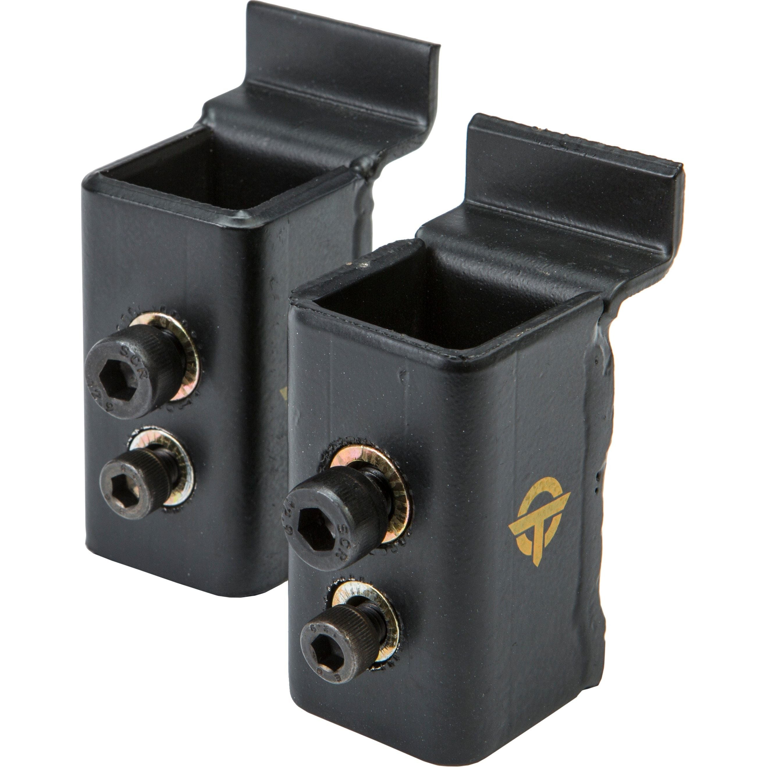 The Lighting Bracket Set by Open Trail includes two black metal rectangular brackets with notched tops, bolts, hex screws, and a yellow logo on the side—designed for attachment or mounting purposes.