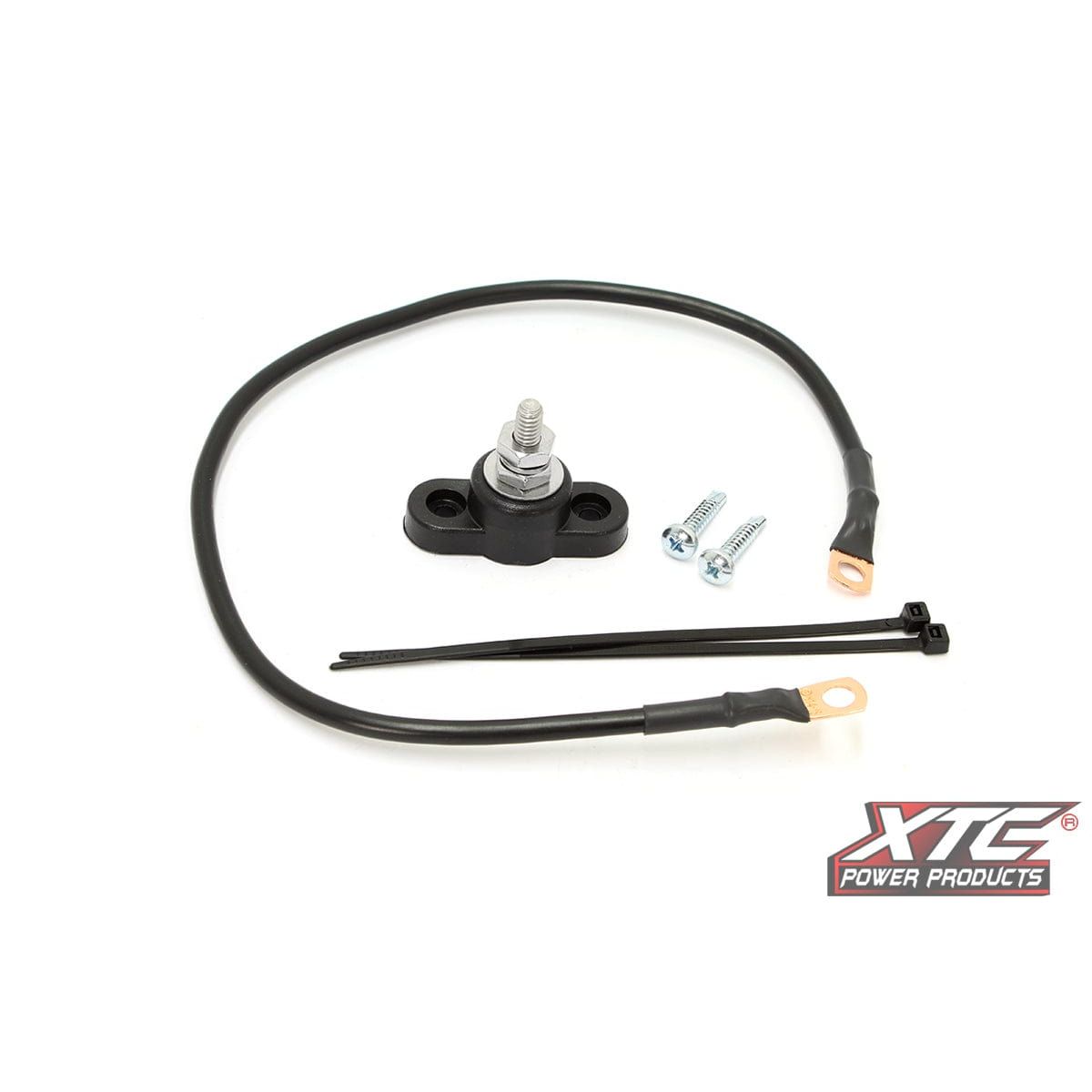 The Universal Ground Post Kit By XTC Power includes a black power wire, fuse holder with bolt, two screws, two zip ties, and features stainless steel hardware plus the XTC Power Products logo on a white background for durability.