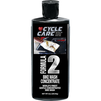 A black bottle labeled Formula 2 Bike Wash 8 U.S. fl oz. by Cycle Care Formulas, with a sponge cleaning a bike; the label highlights its gentle, concentrated formula—safe for paint and chrome, delivering a spot-free wash.