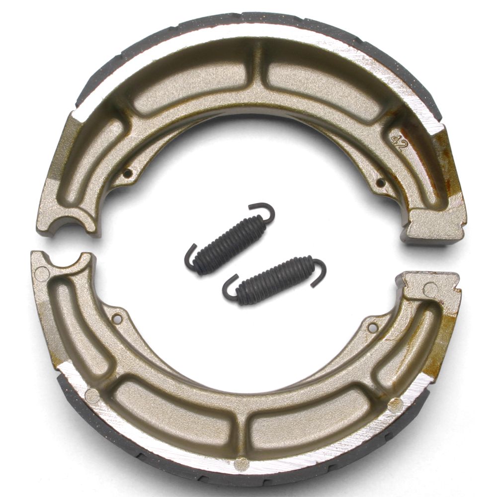 Set of two semi-circular metal brake shoes with grooved surfaces and two black coil springs in the center.
