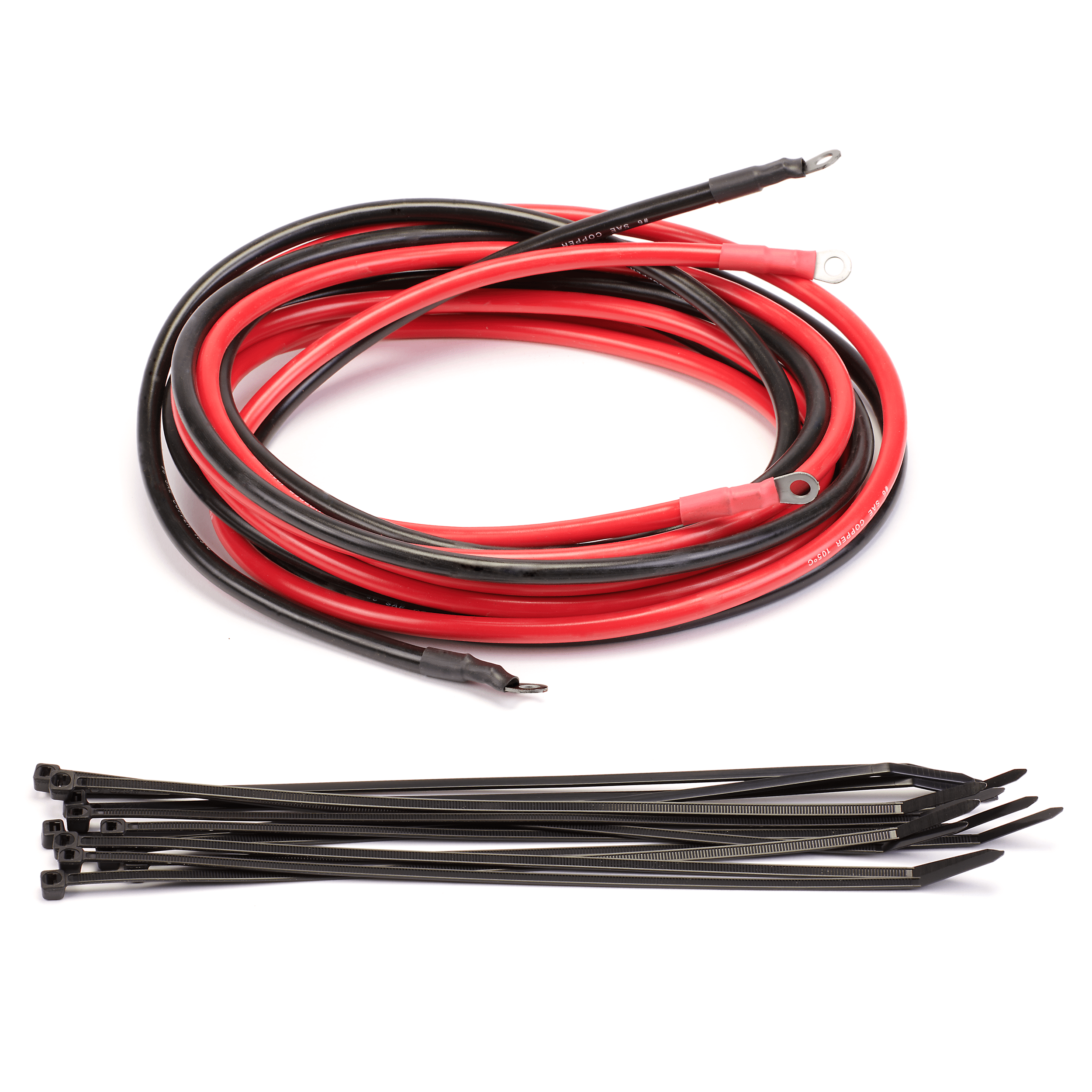The Four Person UTV Wire Harness Kit By Warn, featuring red and black cables with ring terminals coiled together, is shown above a row of black plastic zip ties on a white background.