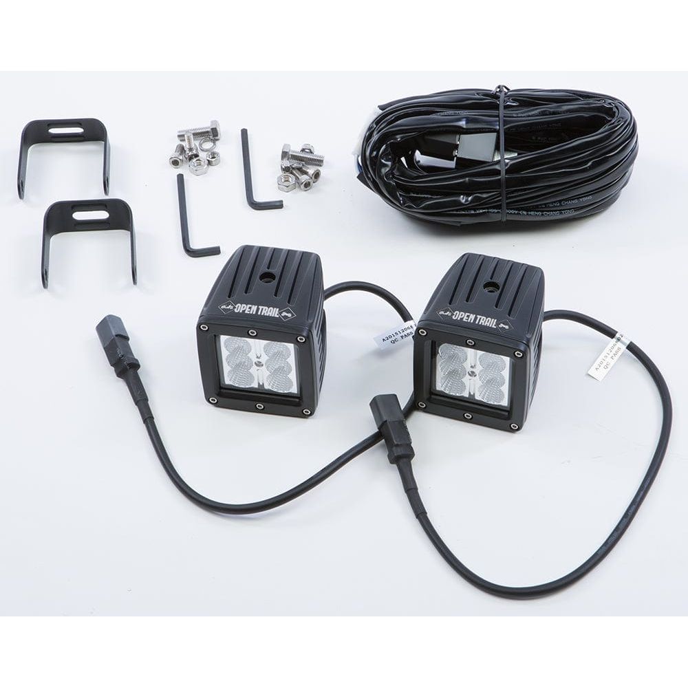 A pair of black cube-shaped 3 x 3 Open Trail LED Flood Lights with Cree LEDs (6000K), wiring harness, mounting brackets, screws, and Allen wrenches are displayed on a white surface.
