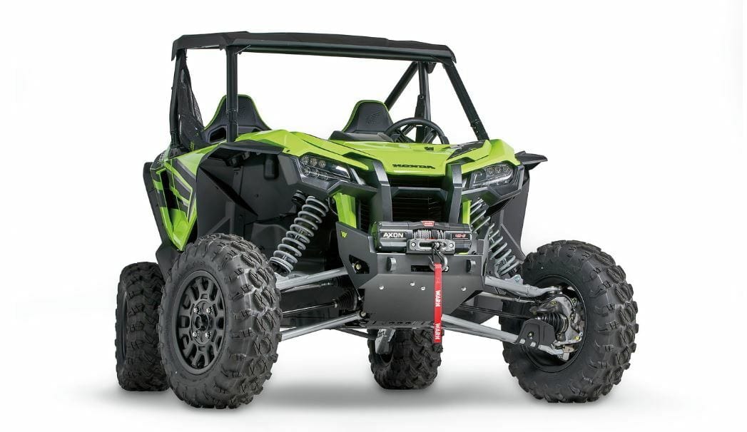 The Honda Talon 1000 SXS Winch Mounting Kit by Warn includes hardware for easy, corrosion-resistant installation of an ATV winch on the front of your bright green, two-seat off-road Honda side-by-side with rugged tires and open sides.