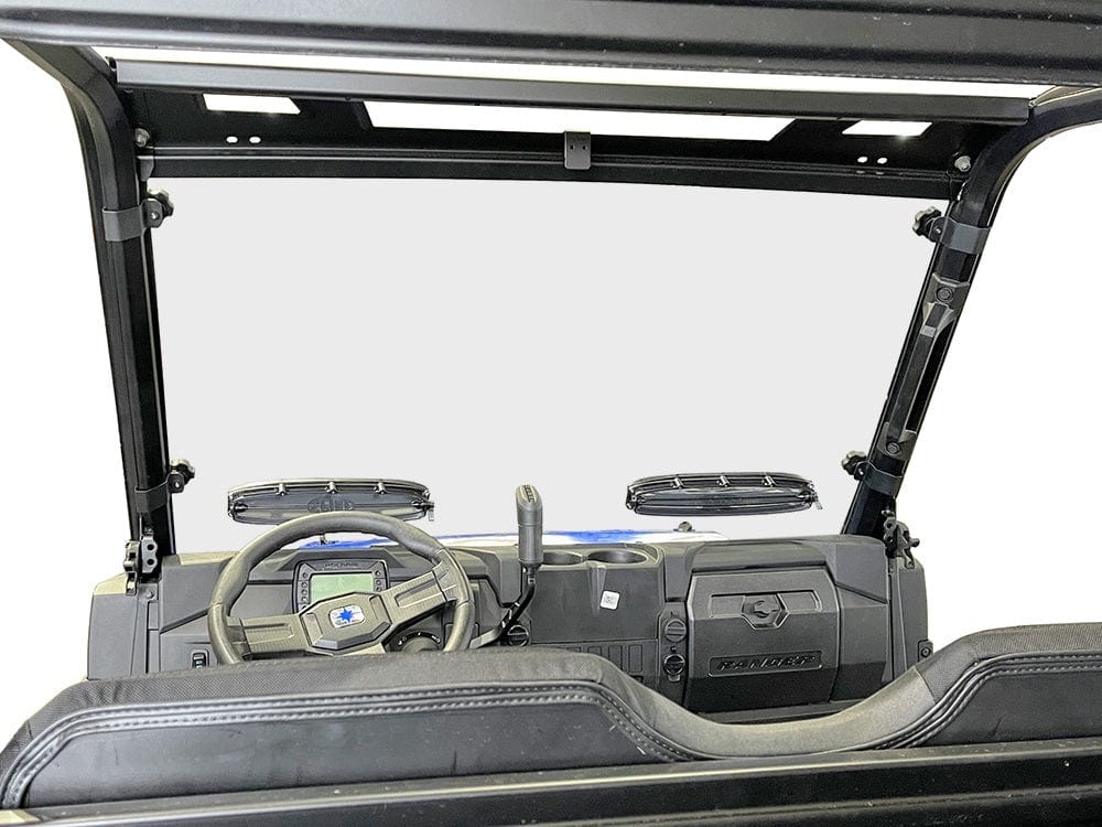 View from the backseat of a utility vehicle shows the steering wheel, dashboard, wipers, and windshield frame. Riding safety is improved with the Polaris Ranger Mid Size Pro-Fit Vented Hard Coated Full Windshield by Spike. The background is featureless.