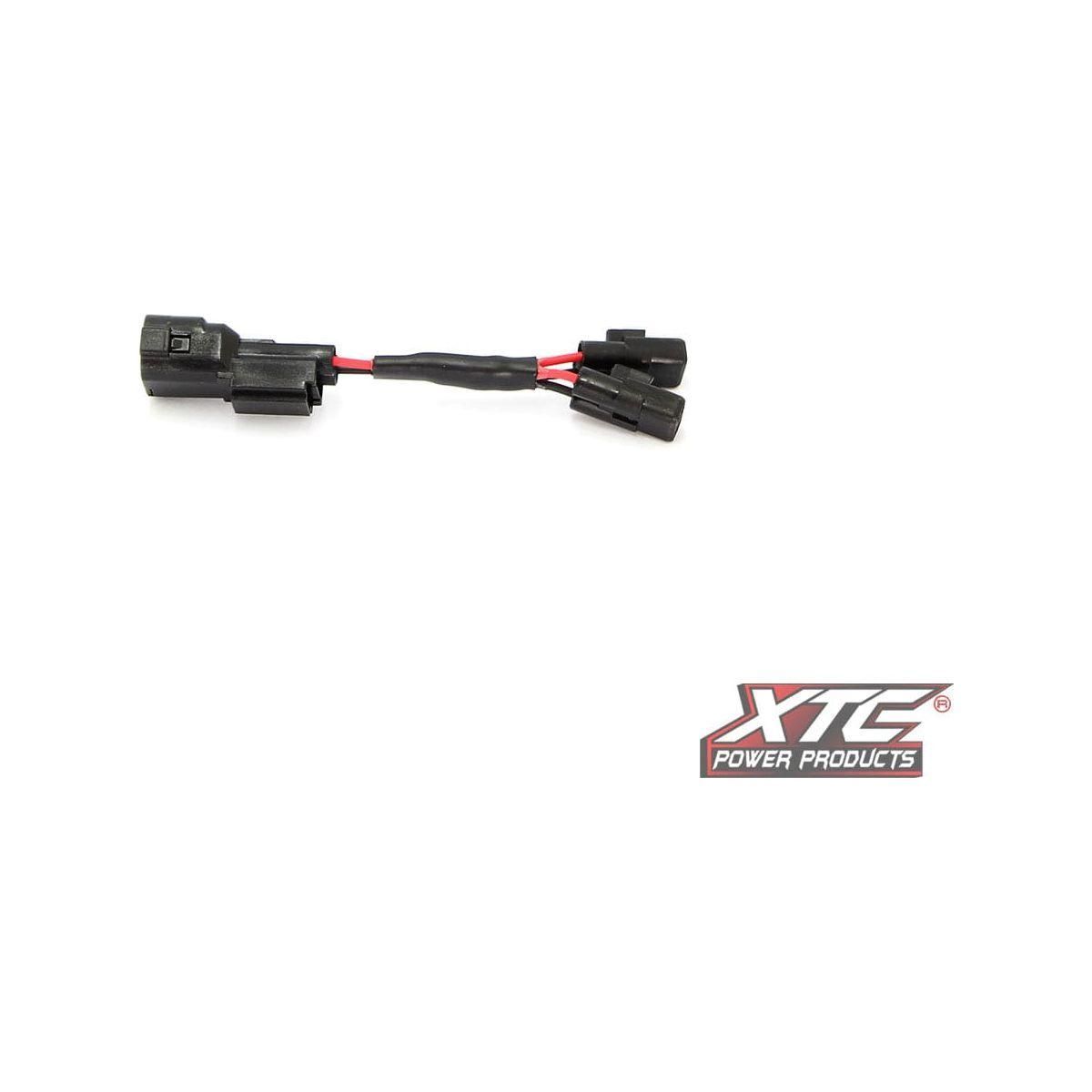 The Plug N Play Power Out Aux Splitter Hon by XTC Power is a black Y-splitter cable with red and black wires, connectors on each end, and the XTC Power Products logo in the bottom right corner on a white background.