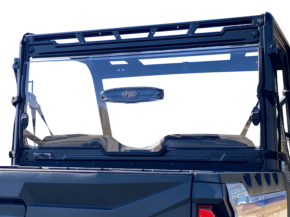 A Polaris Ranger Mid Size Vented Rear Windshield by Spike is mounted on a dark blue off-road utility vehicle, offering sturdy off-road protection with a black metal frame and latch—available at Witchdoctors.com.