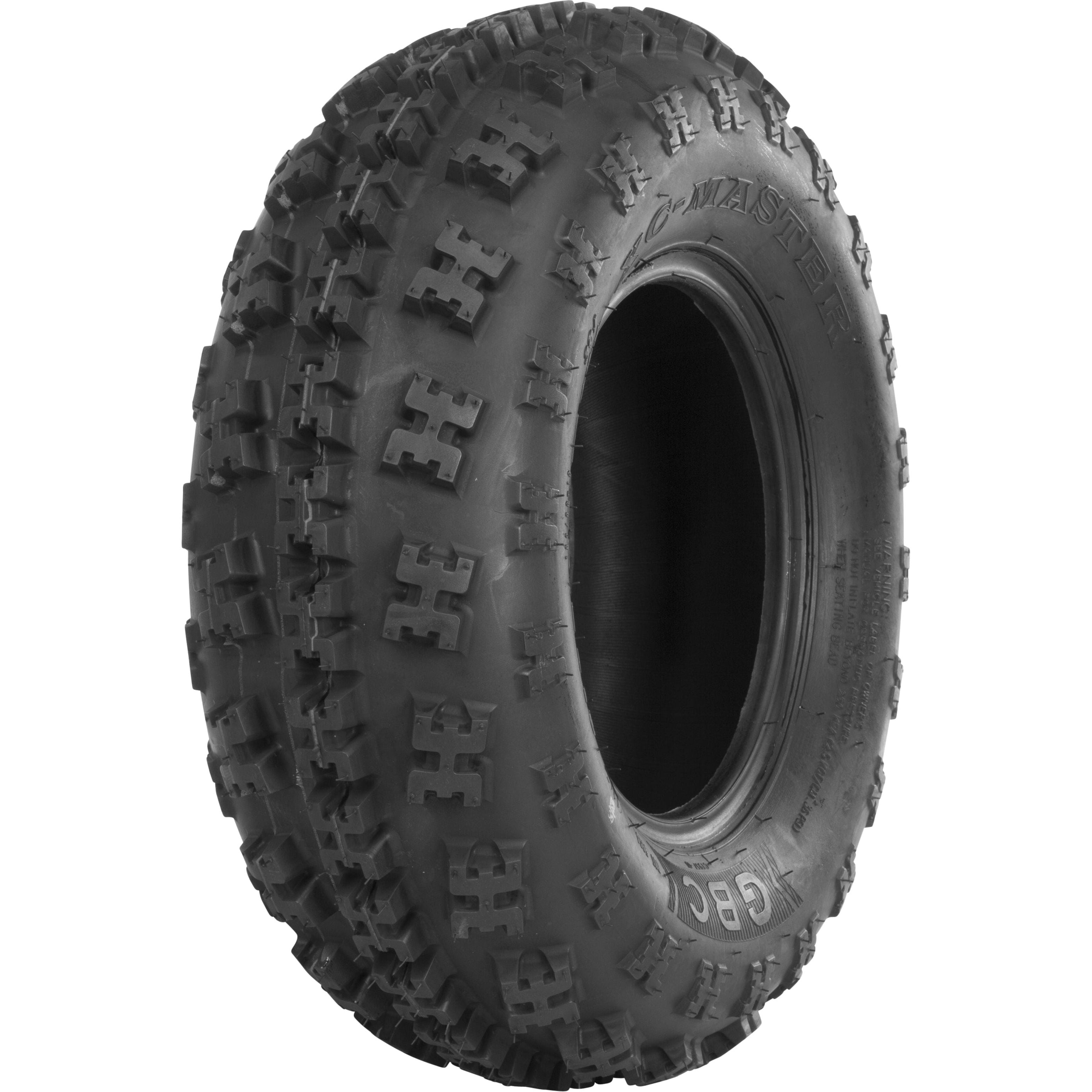 The GBC Tire Xc Master Front 23X7-10 Bias Lr275Lbs stands upright, showcasing a deep X-knob tread for all-terrain use, puncture-resistant casing, and bold sidewall markings. The new black tire is ruggedly built for off-road conditions.