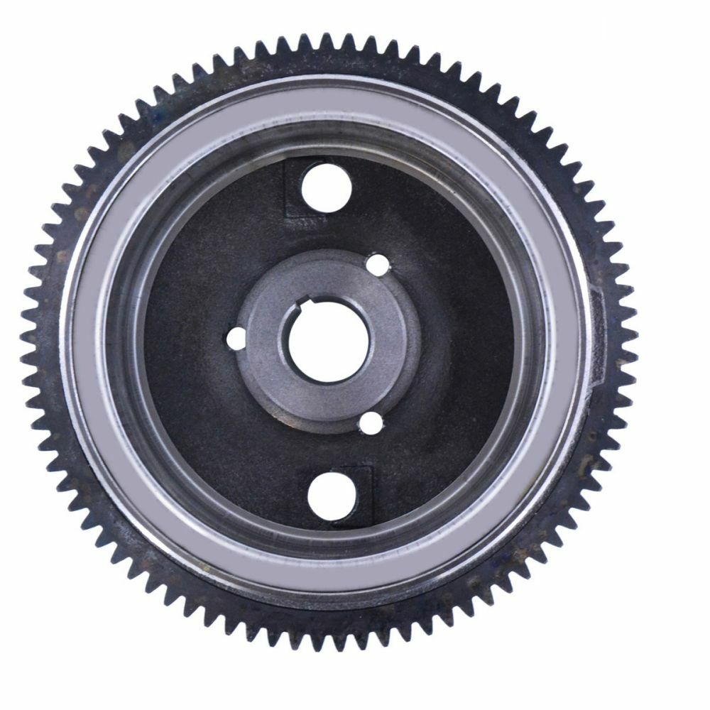 Black and silver circular metal flywheel with evenly spaced outer gear teeth and central mounting holes.
