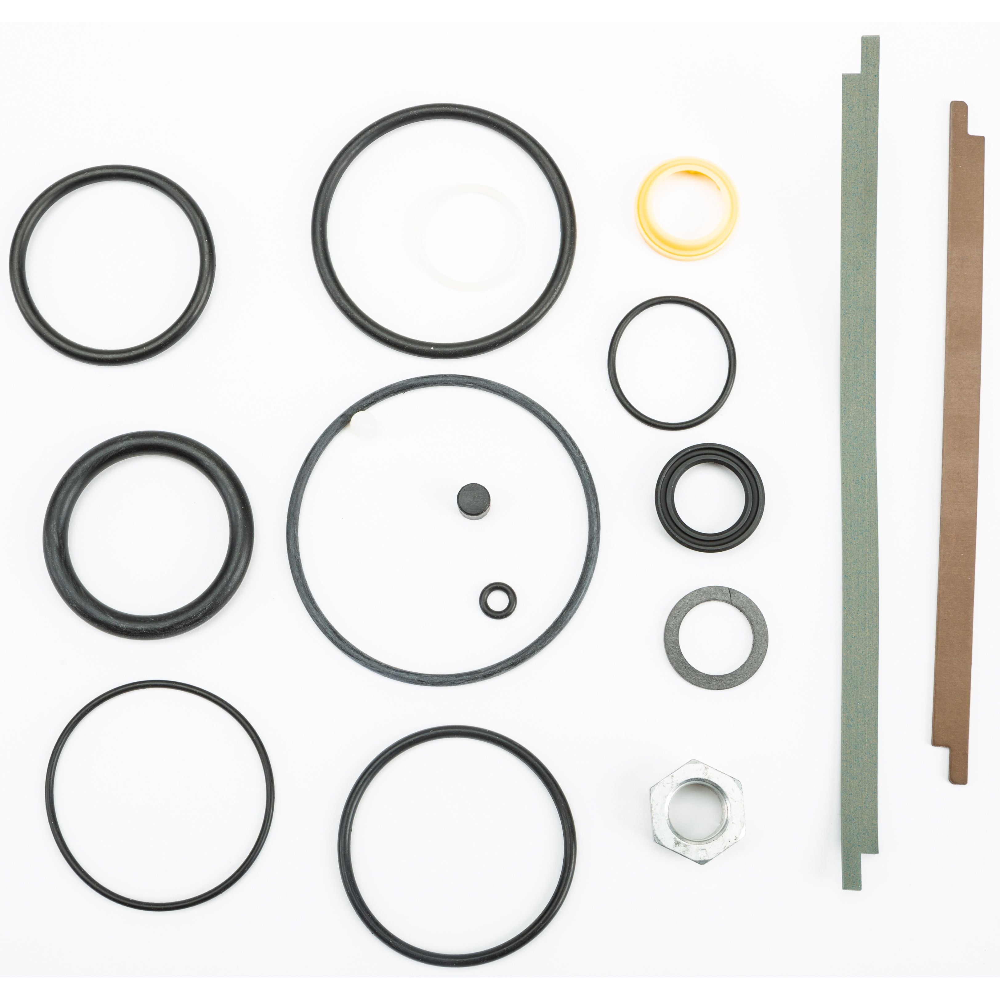 The UTV 2.5 OE Shock Rebuild Kit Replacement Parts by Fox includes assorted black rubber O-rings, white and yellow rings, a metal hex nut, and two gasket strips (green and brown), all arranged on a white background.