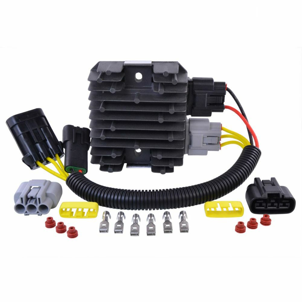 Black finned aluminum regulator with multiple connectors, wiring harness, metal terminals, and red wire seals laid out on.