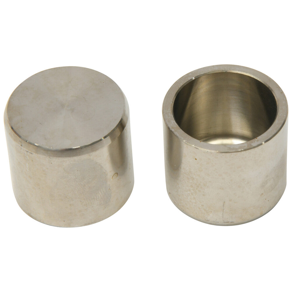 Two cylindrical silver metal brake caliper pistons, one showing a solid top and the other hollow inside.