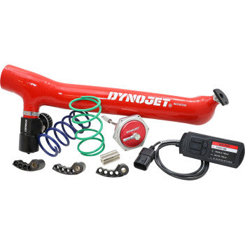 A Polaris Stage 3+ Power Package Kit by Dynojet, featuring an intake pipe, springs, Power Vision 3 electronic controller, actuator, and assorted small components displayed on a white background.