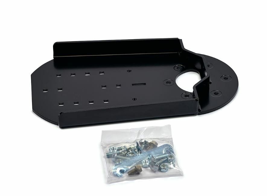 The UTV Snow Plow Push Tube Extension by Warn features a black metal mounting plate with raised edges and multiple holes, shown beside a clear bag containing assorted screws, bolts, nuts, and brackets on a white background.