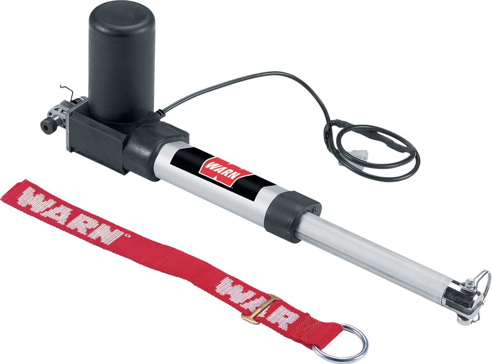A Snow Plow Electric Lift System by Warn features a black motor housing, silver extending rod, attached cable, and a red WARN-branded safety strap with metal ring.