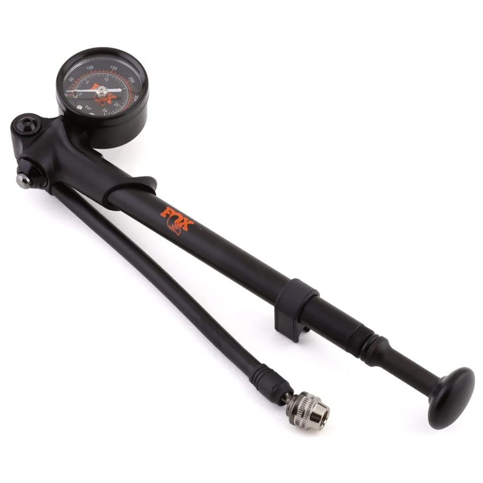 The Foldable Pump 300 Psi by Fox is a black shock pump with a pressure gauge, flexible hose, and silver valve head, designed for inflating mountain bike suspension components.
