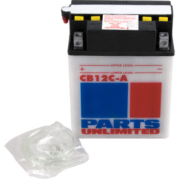 A rectangular Parts Unlimited Battery YB12C A with red and blue labels, black top, and yellow caps sits next to a coiled plastic tube in a clear bag—engineered for powerful starting performance.