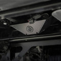 Black triangular metal camera mount with a circular amber LED light in the center, wired connection visible.