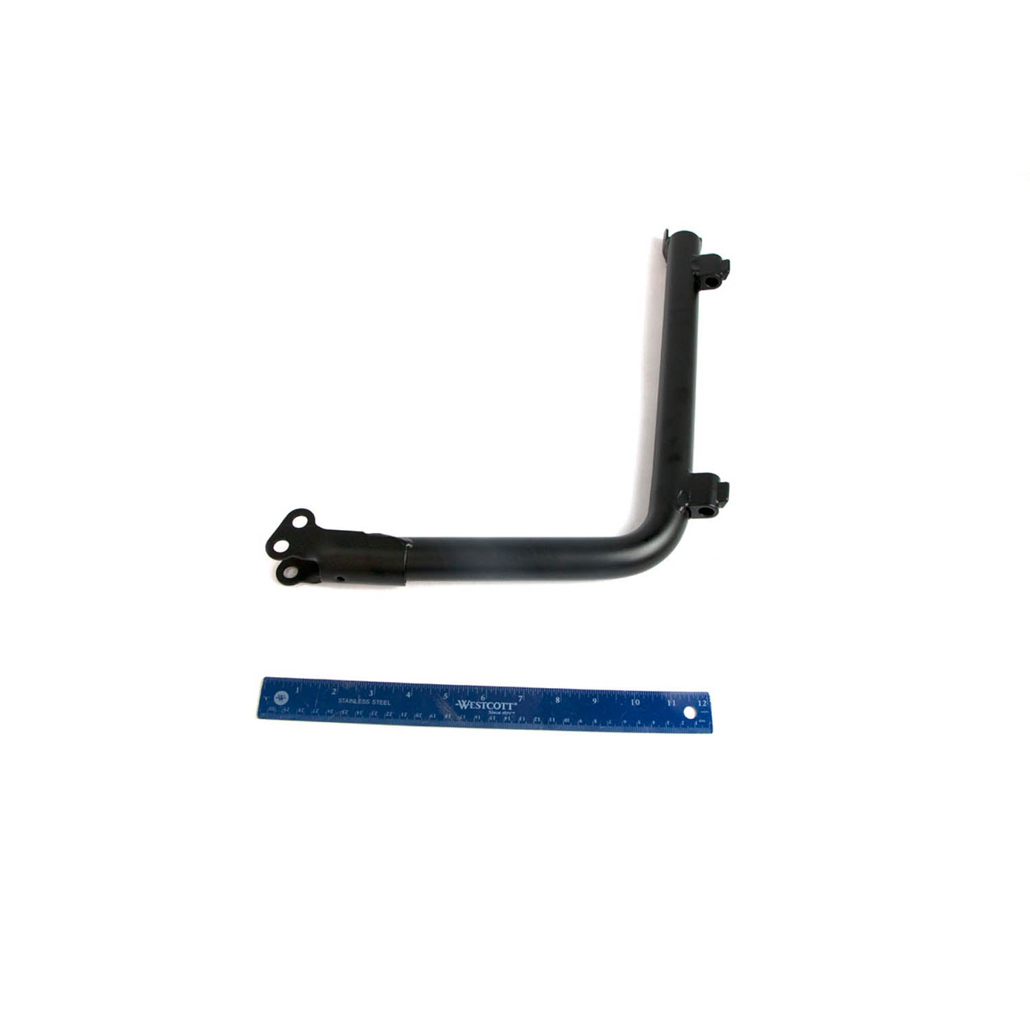 Matte black L-shaped metal bolster bar with mounting holes and brackets, 12-inch blue ruler below.