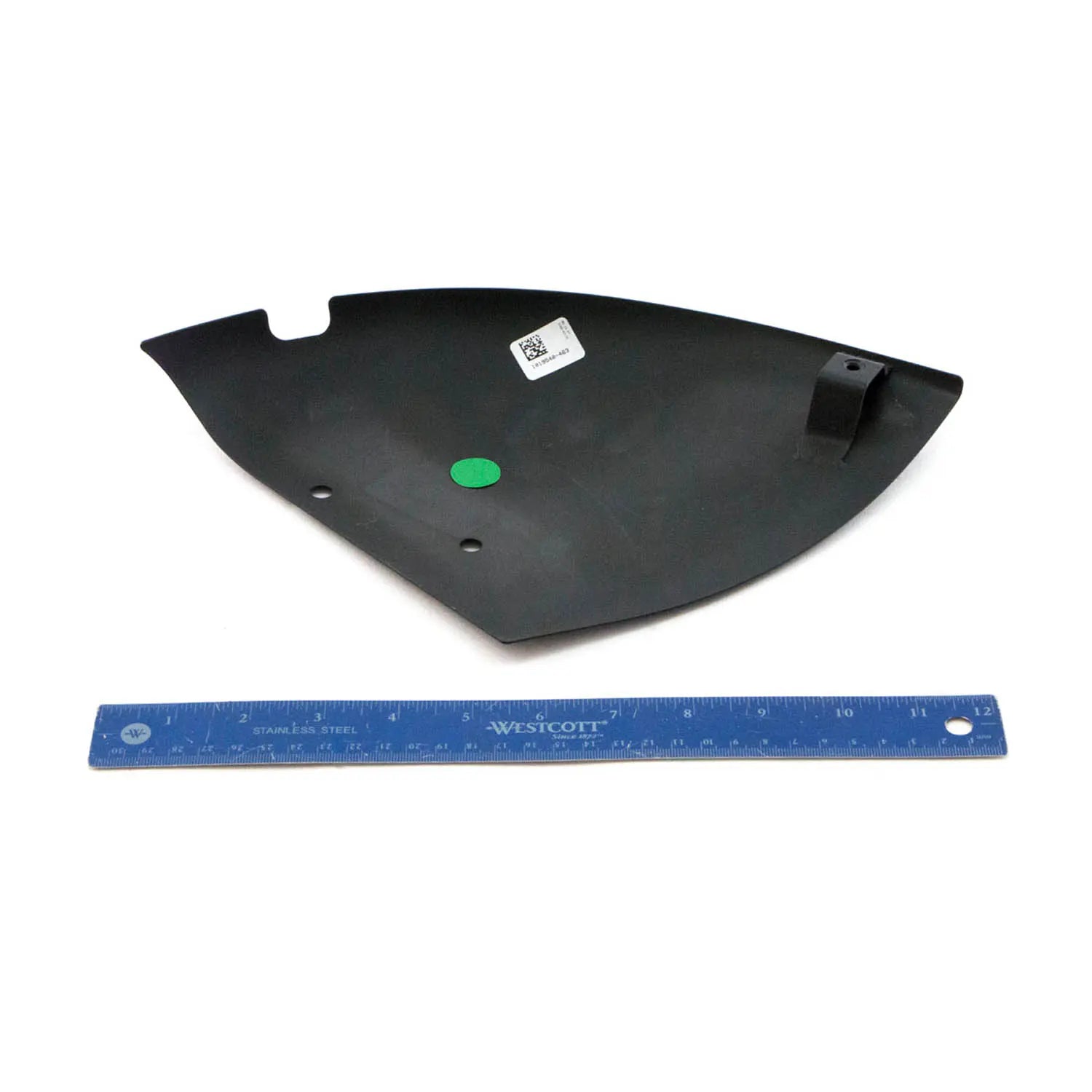 Matte black curved brake caliper cover with mounting holes, shown next to blue ruler for scale.