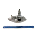 Silver metal water pump with central shaft and multiple inlet/outlet ports, alongside blue ruler for scale.